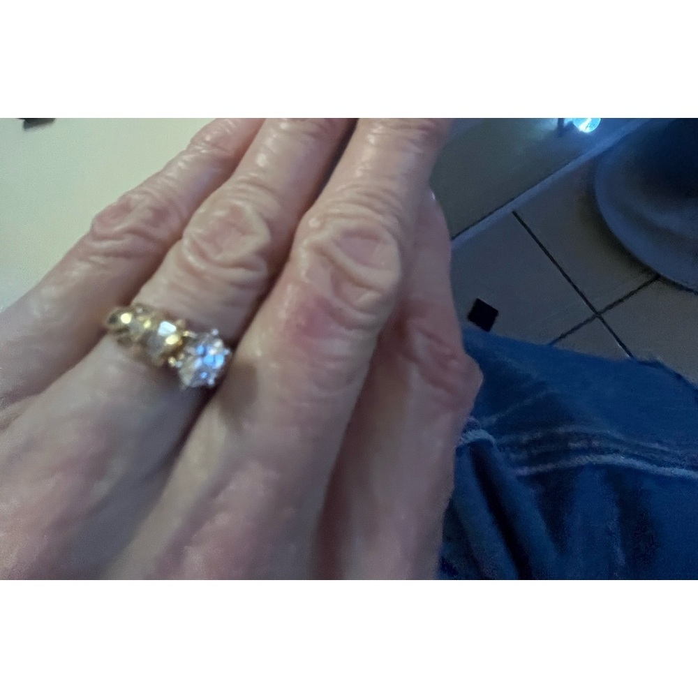 Very Nice Women’s 14K Yellow Gold Ring
With CZ Stones beside the center stone